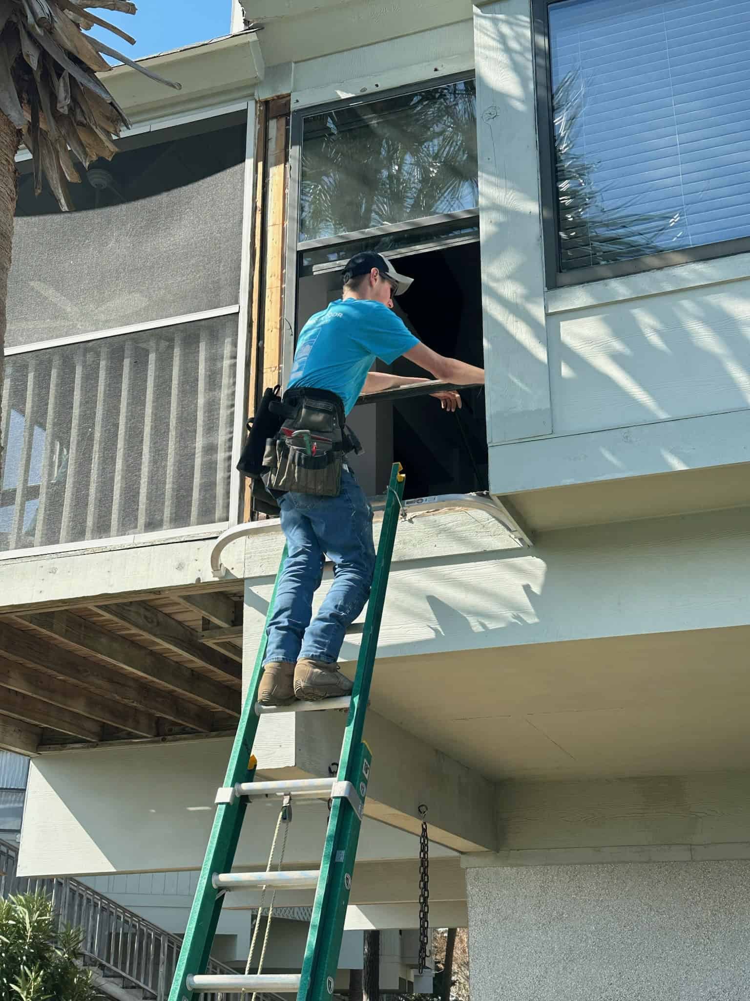 Owner working on a window from a ladder.